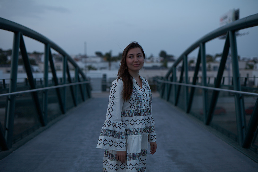 Brunette girl in white dress on the bridge