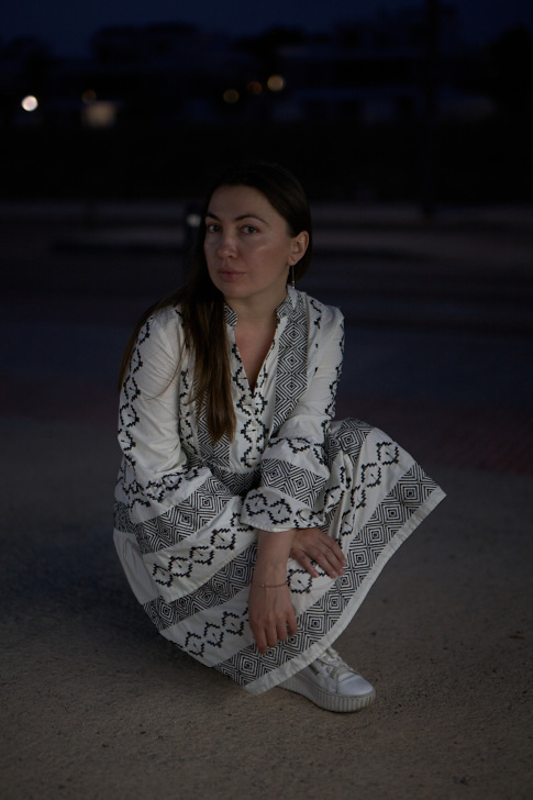 Brunette girl in white dress on the bridge